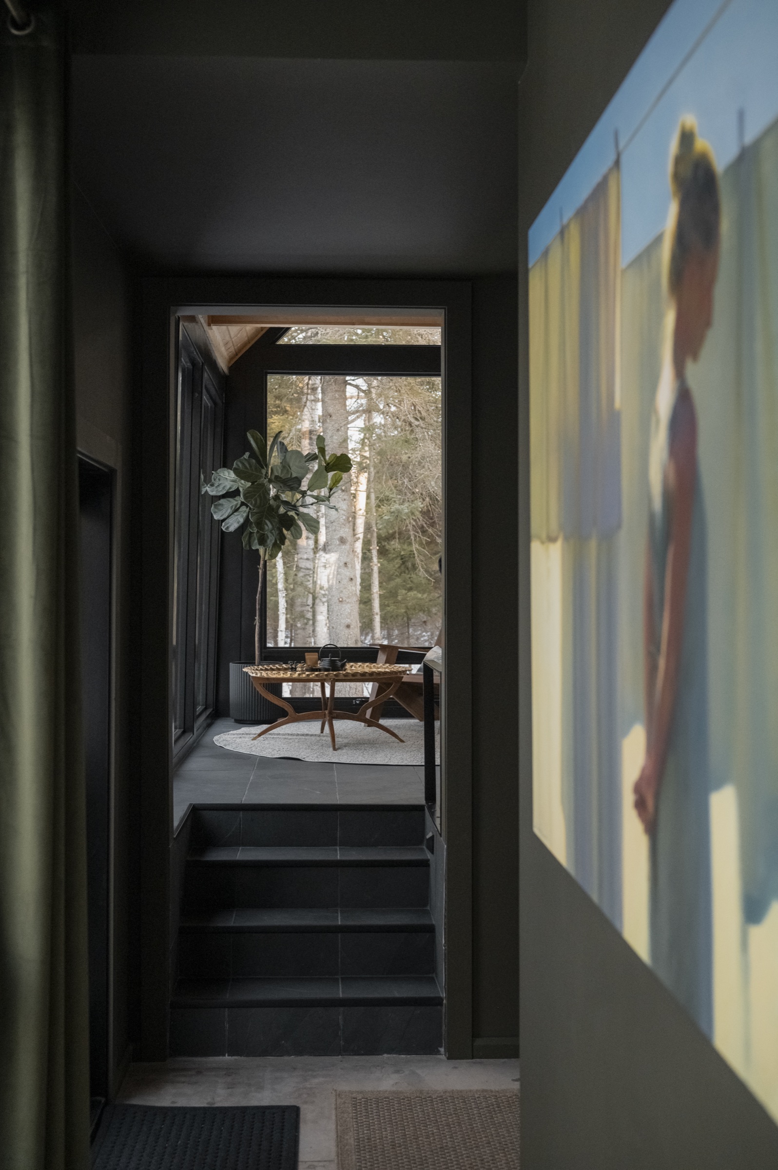 Hallway with art leading to sunken living room