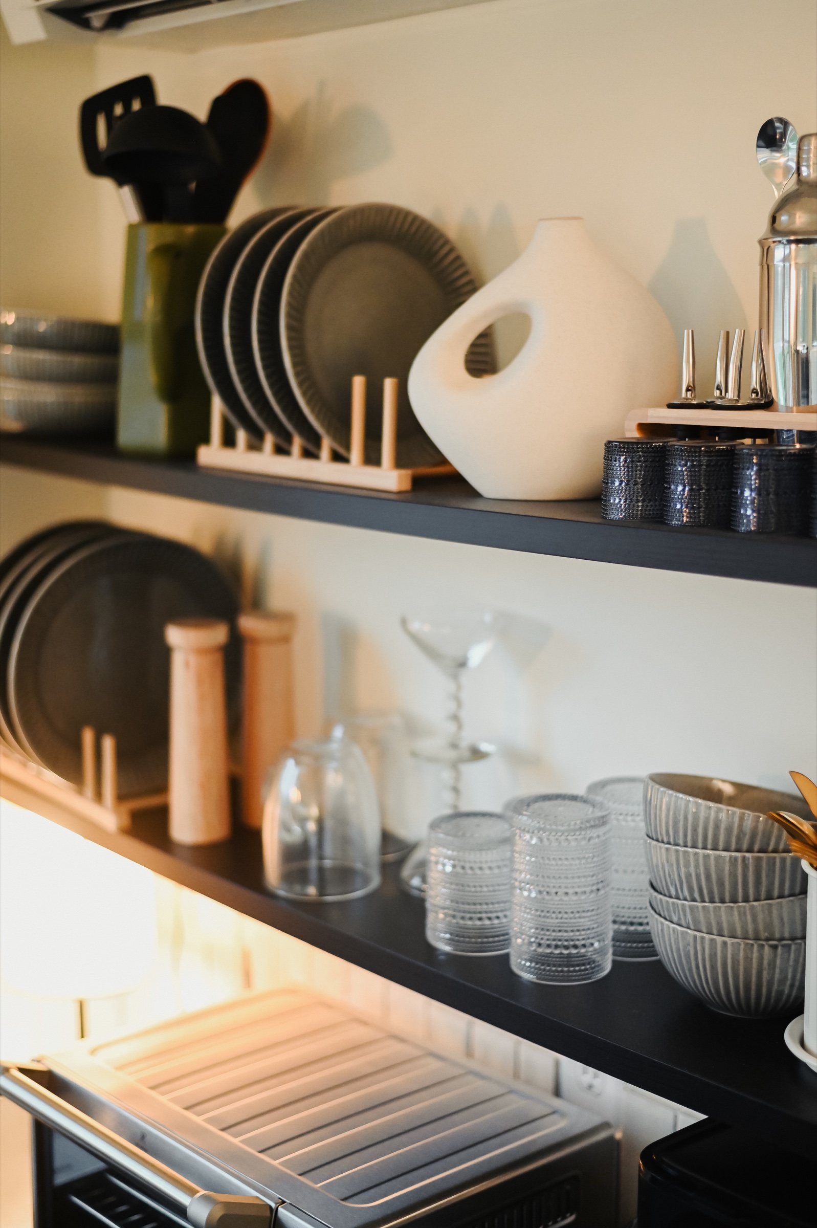 Open kitchen shelving with curated ceramics and glassware