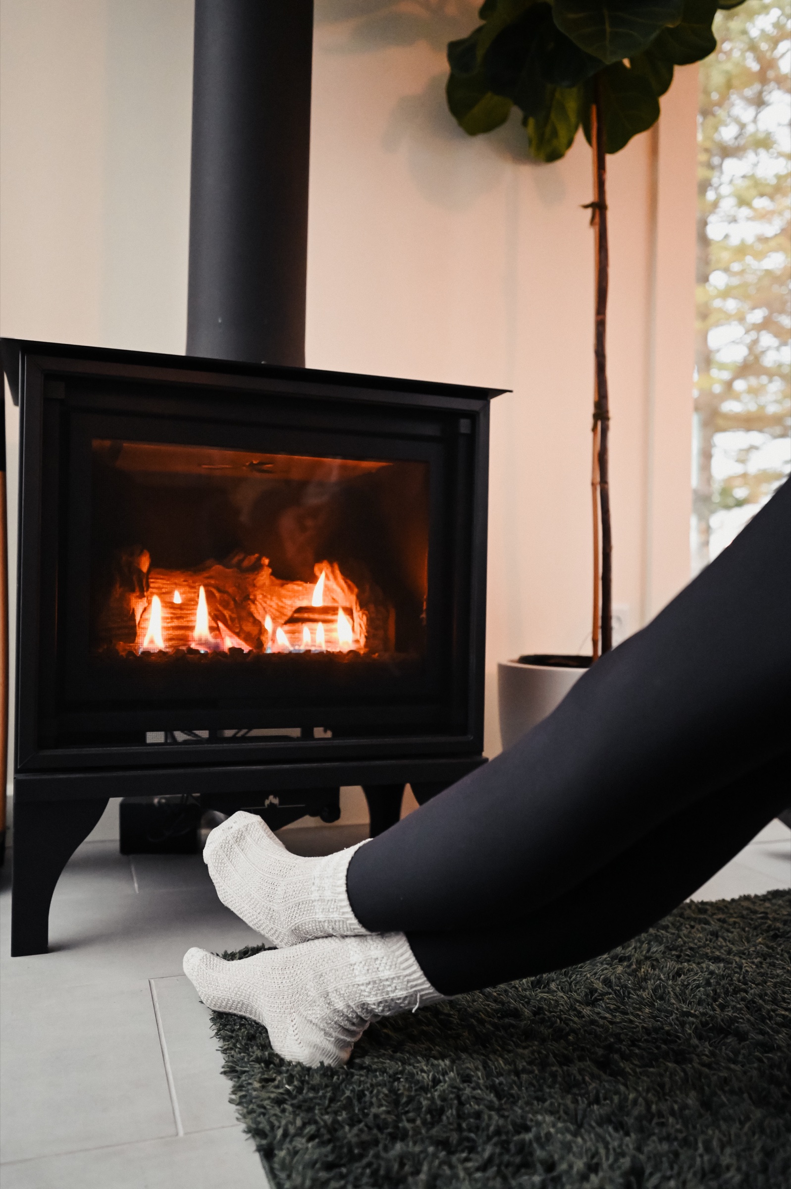 Cozy moment by the fireplace in wool socks