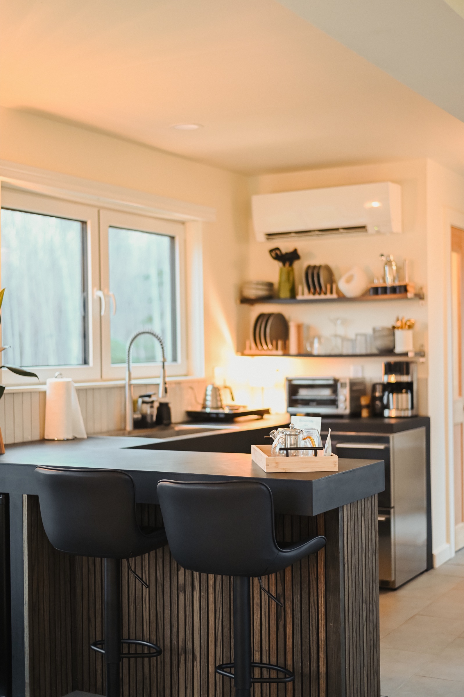 Kitchen island with bar stools and open shelving