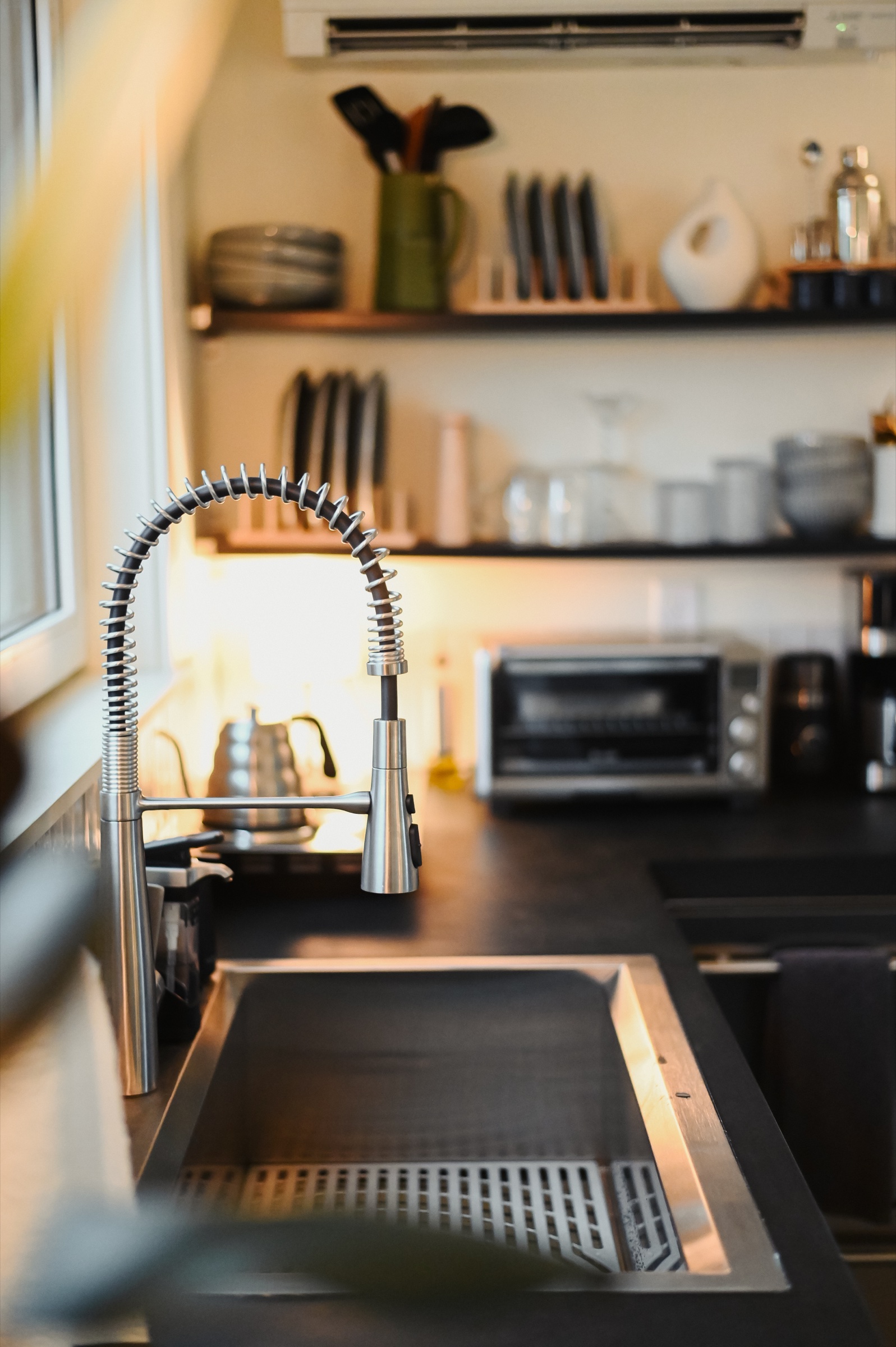 Kitchen sink with gooseneck faucet and curated dishware